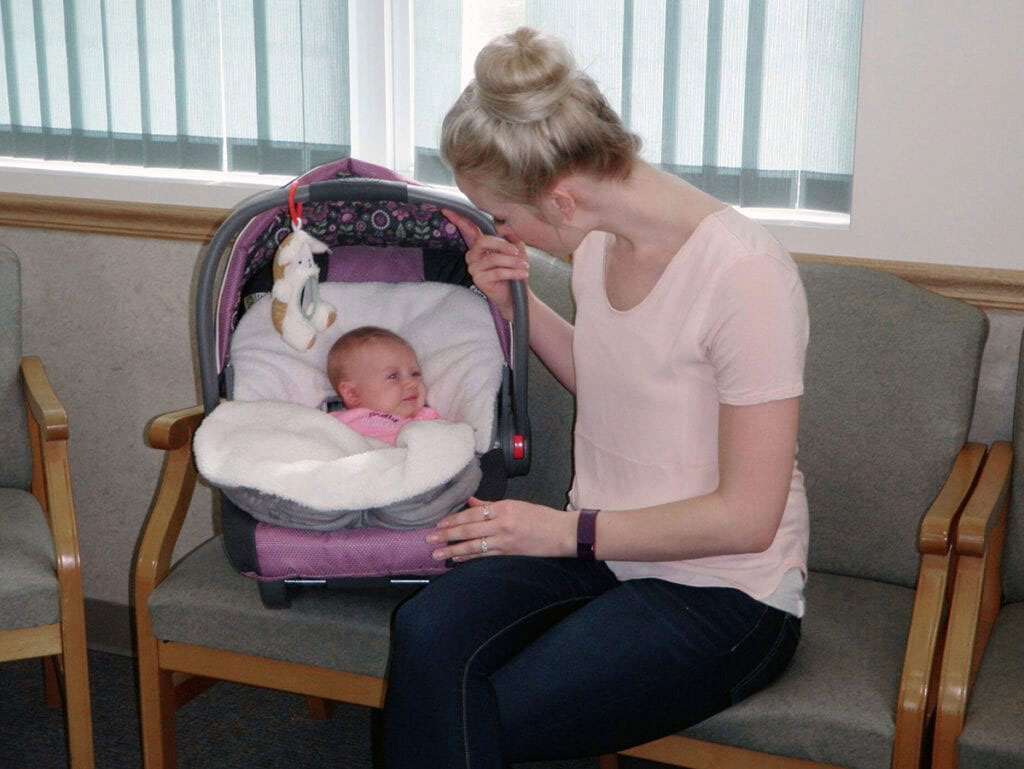 Mother with her baby in waiting room in Hamilton new york