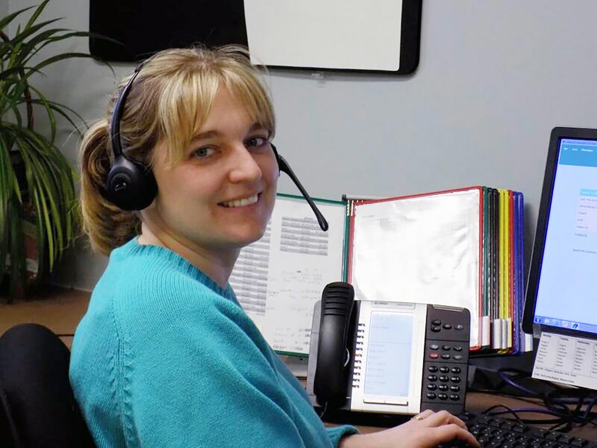 Woman answering phones at Morrisville family health center