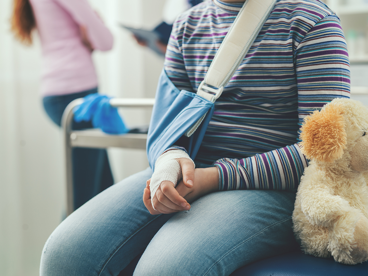 Girl with broken arm in the doctor's office, wearing an arm brace