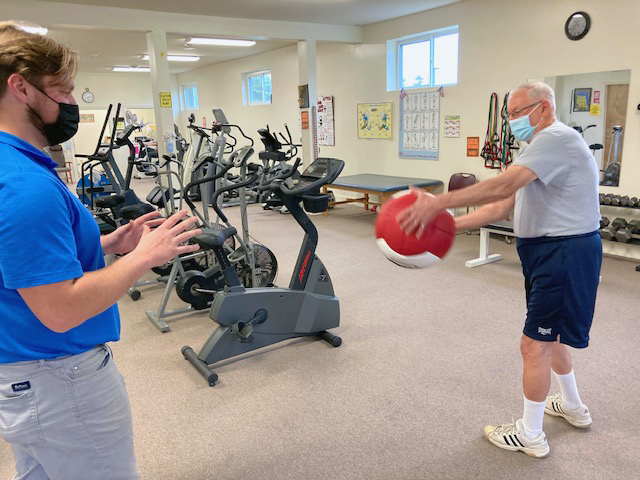 Man with medicine ball at wellness center community memorial hospital