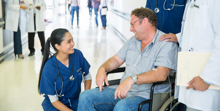 Doctor talking to patient in wheelchair