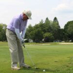 Golfer preparing to drive a ball