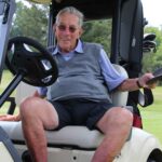 Smiling man in a golf cart