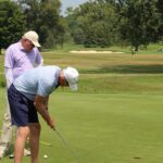 Golfer putting on green