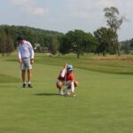 Golfers putting on a green