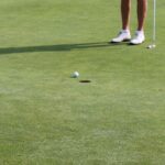 Golfers putting on a green