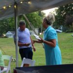 Woman passing out envelopes