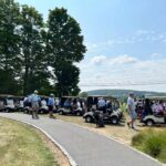 Golfers heading to their golf carts