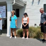 Four people getting ready to play golf in a fund raising event