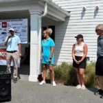 Four people getting ready to play golf in a fund raising event