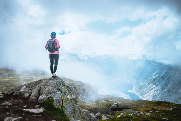 Happy sporty woman enjoy beautiful lake in Norway mountains