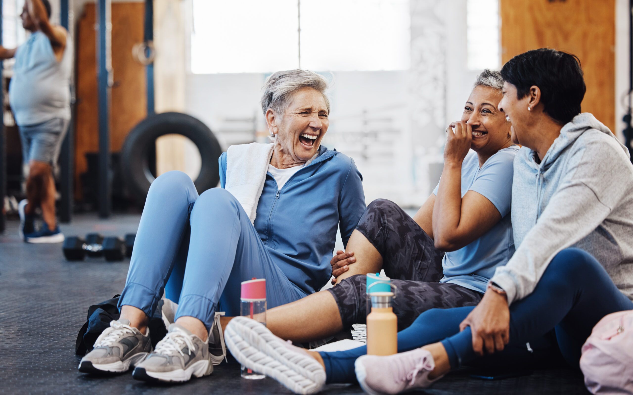 People at a gym laughing after workout